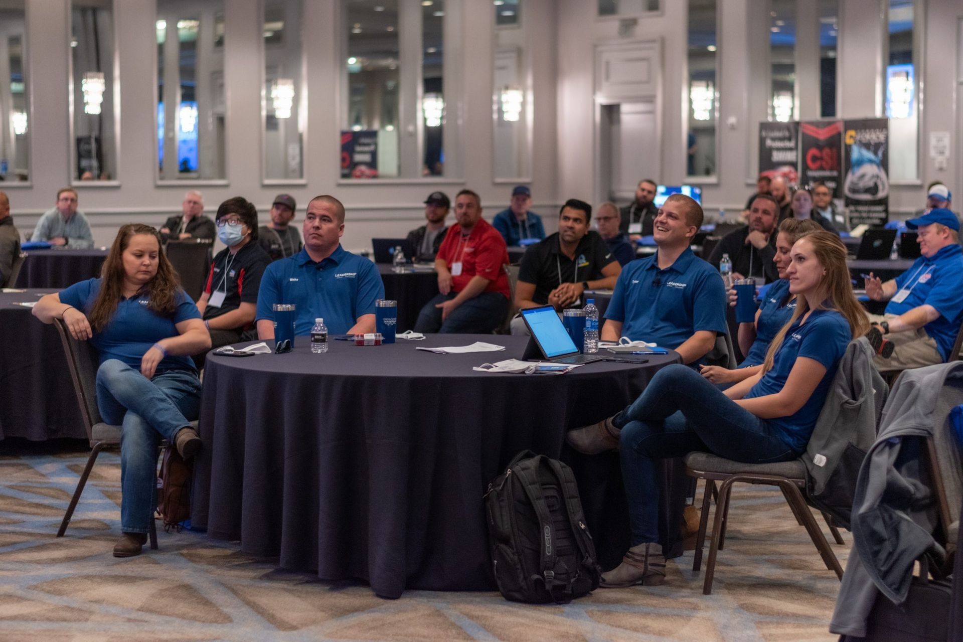 A group of people are sitting at tables in a room.
