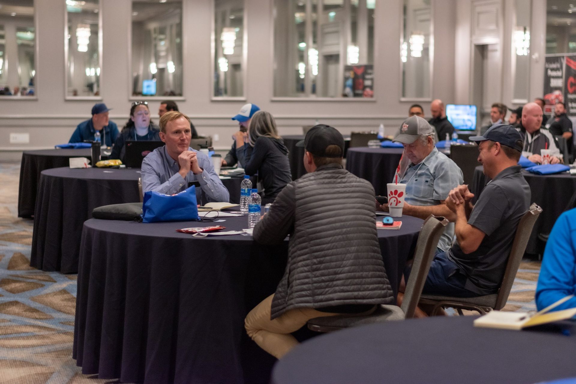 A group of people are sitting at tables in a room.