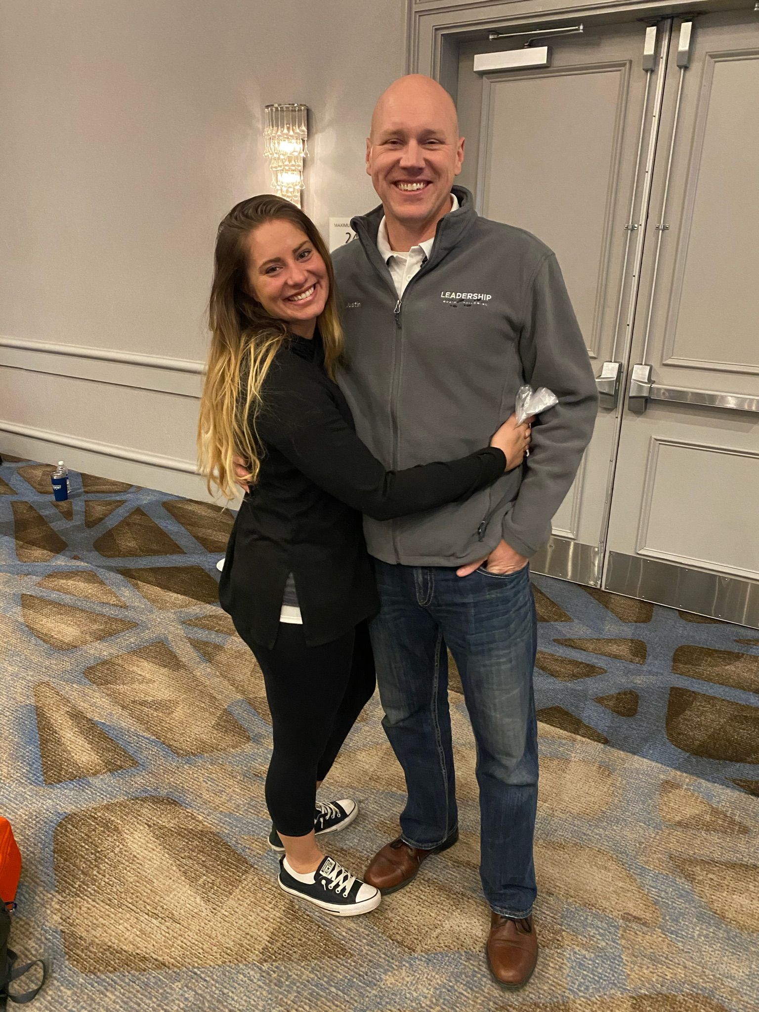 A man and a woman are hugging each other in a room.