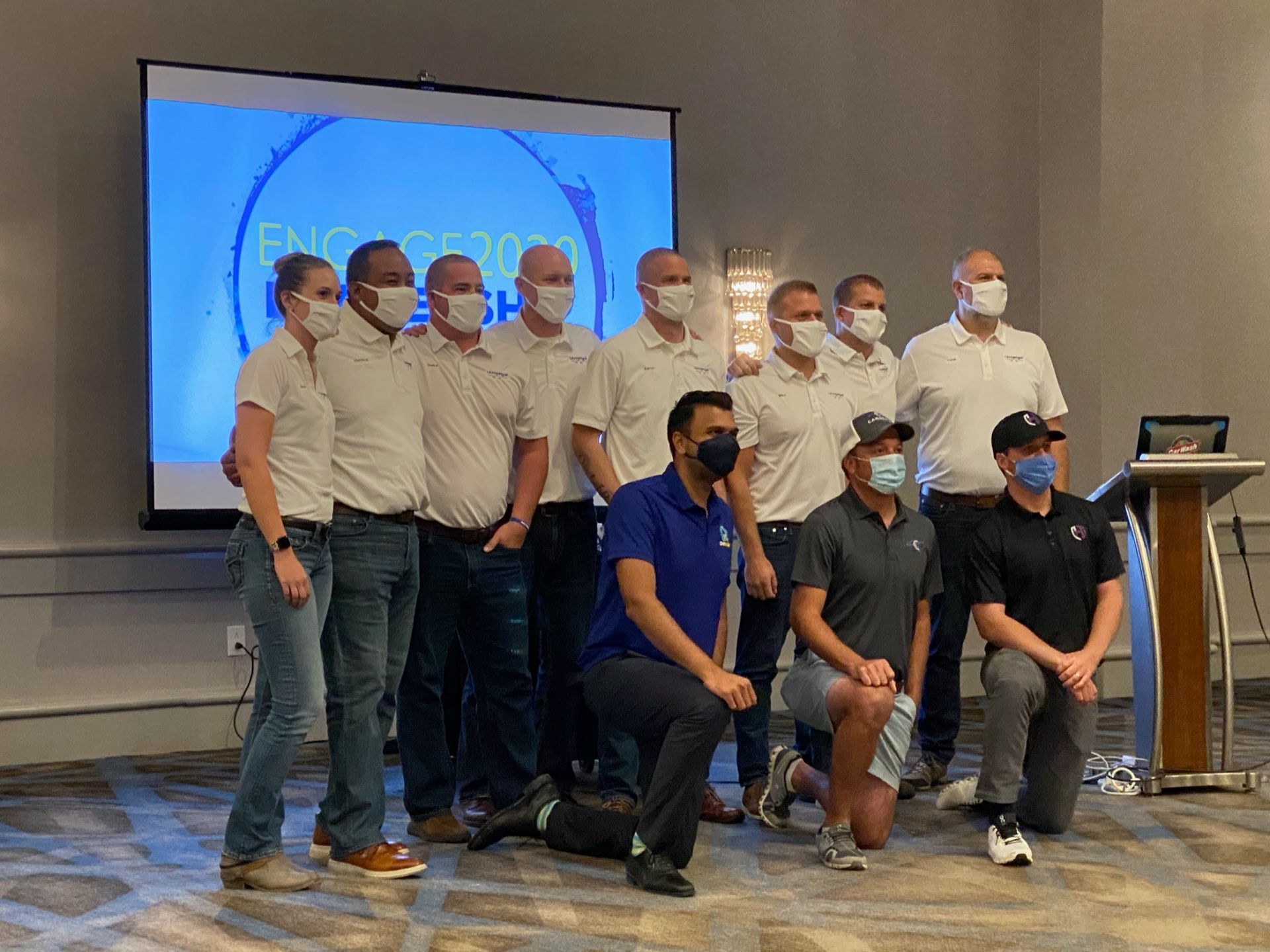 A group of men wearing face masks are posing for a picture.