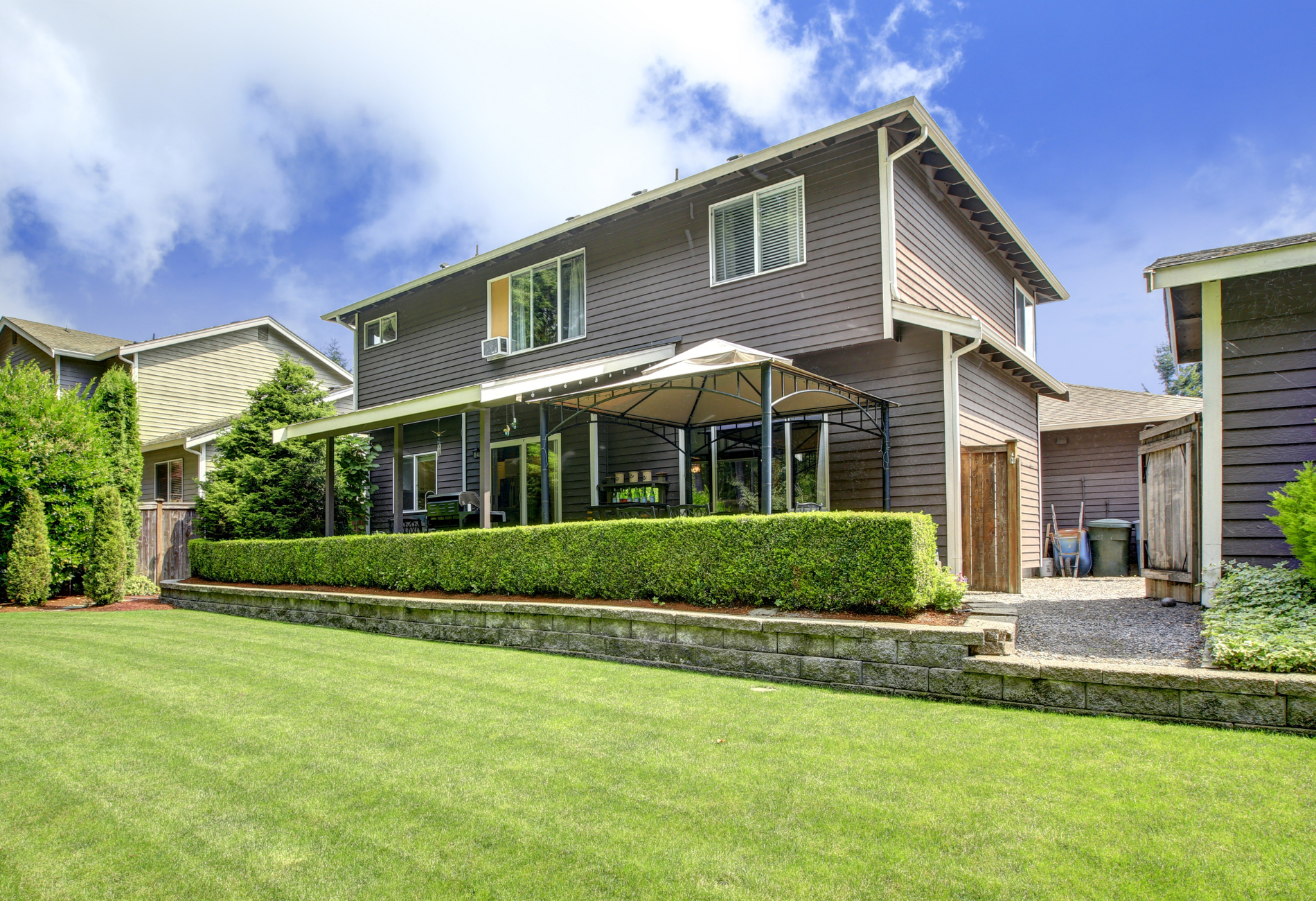 A large house with a large lawn in front of it.