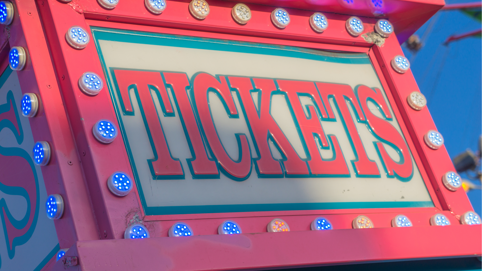 Man with glasses, working on a laptop at a desk with a coffee mug and papers.