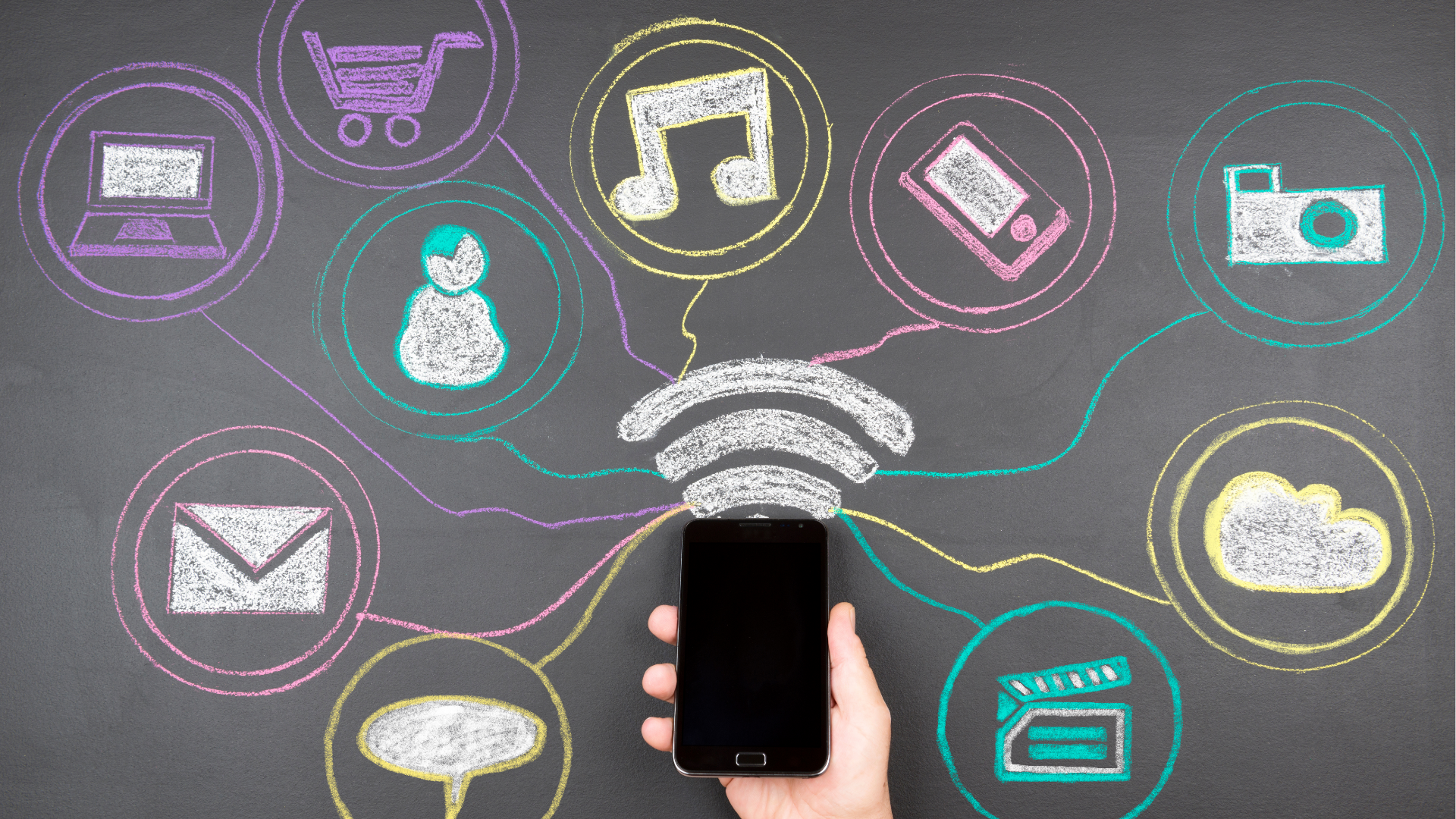 Man with glasses, working on a laptop at a desk with a coffee mug and papers.