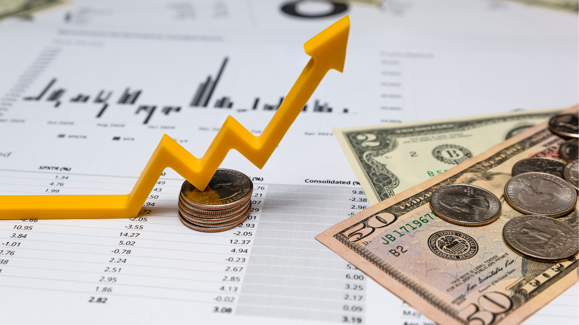 Man typing on keyboard, coding on dual computer monitors, at a desk in a dimly lit room.