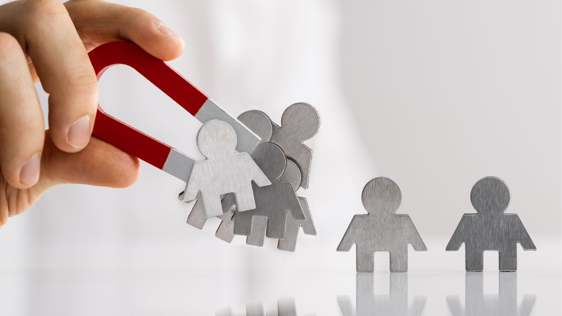 Man typing on keyboard, coding on dual computer monitors, at a desk in a dimly lit room.