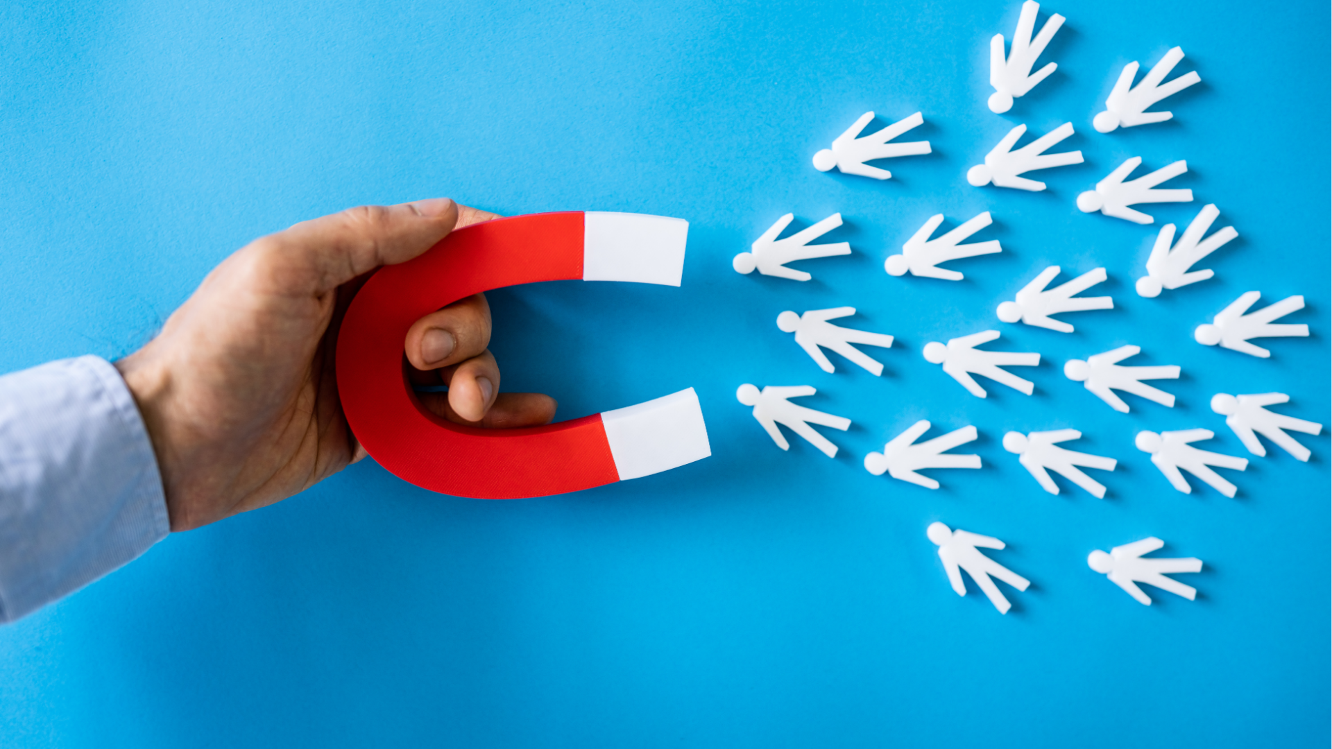 People at a table looking at laptops. They are smiling and working in a modern office.