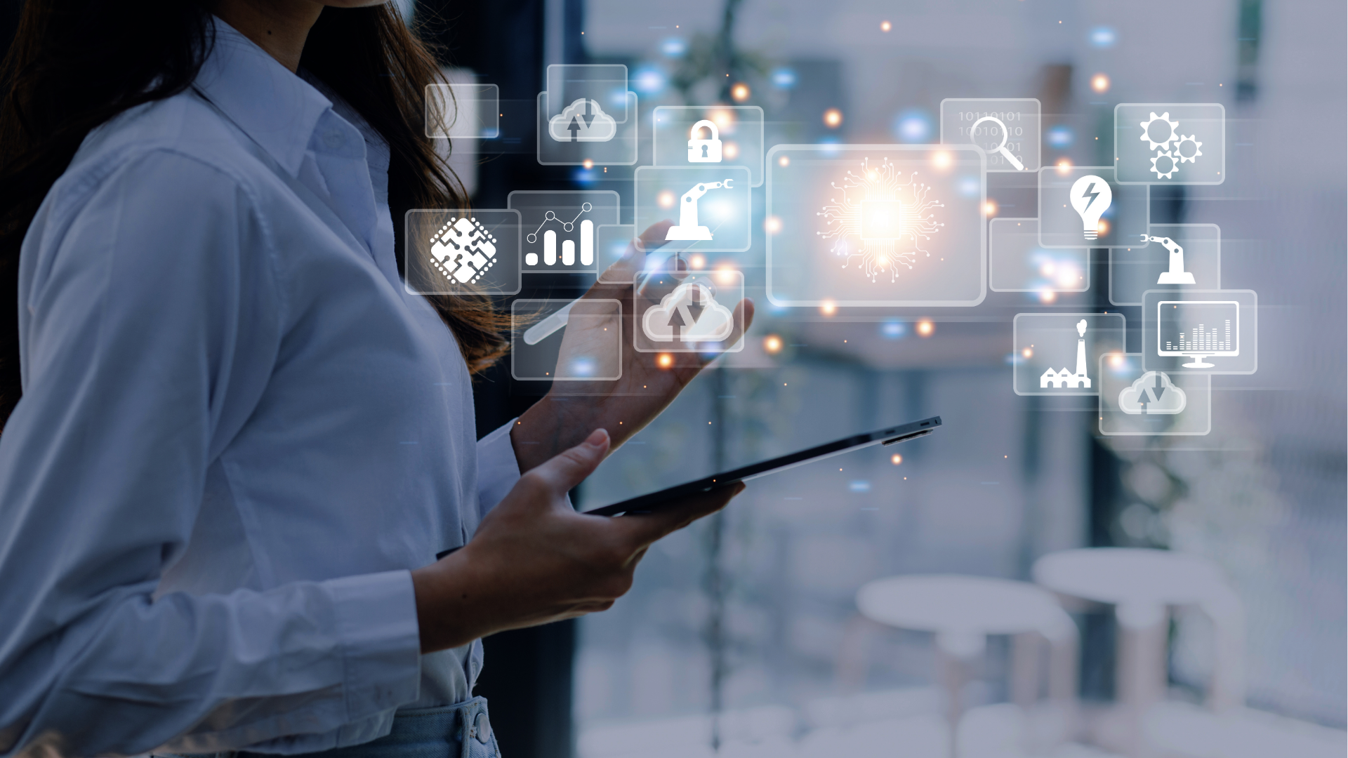 People at a table looking at laptops. They are smiling and working in a modern office.