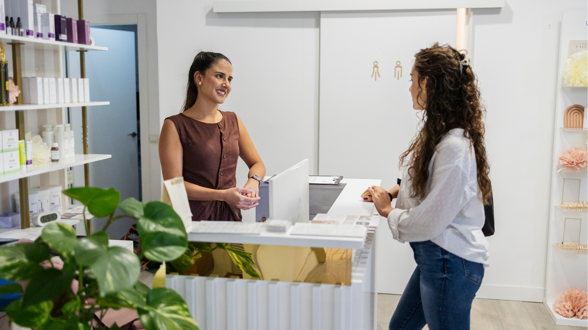 Man with glasses, working on a laptop at a desk with a coffee mug and papers.