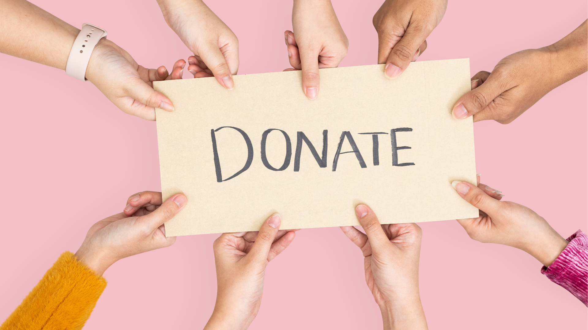 Man typing on keyboard, coding on dual computer monitors, at a desk in a dimly lit room.