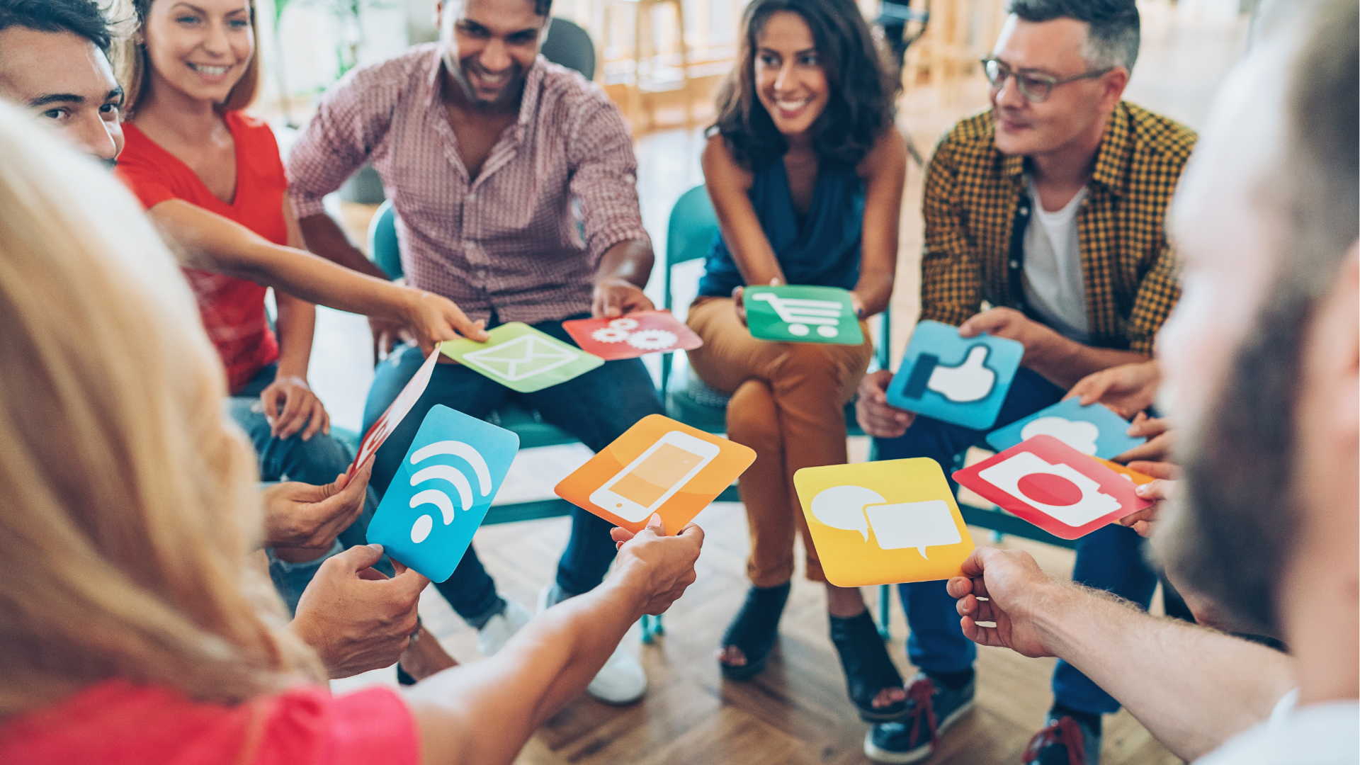 Person typing on laptop, viewing financial charts and pie chart. Phone rests beside the laptop on wooden table.