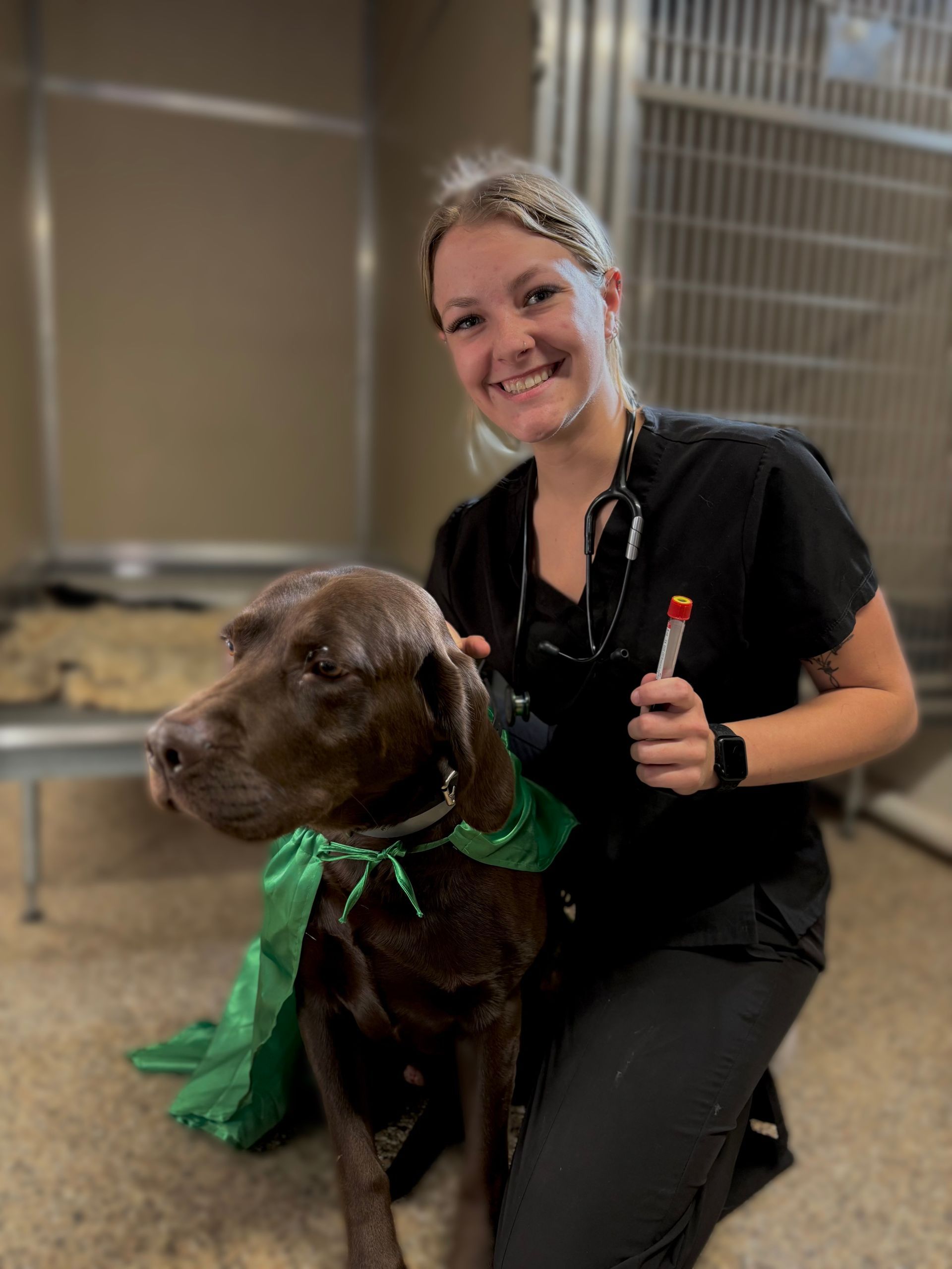 a woman in a red shirt with the word veterinarian on it