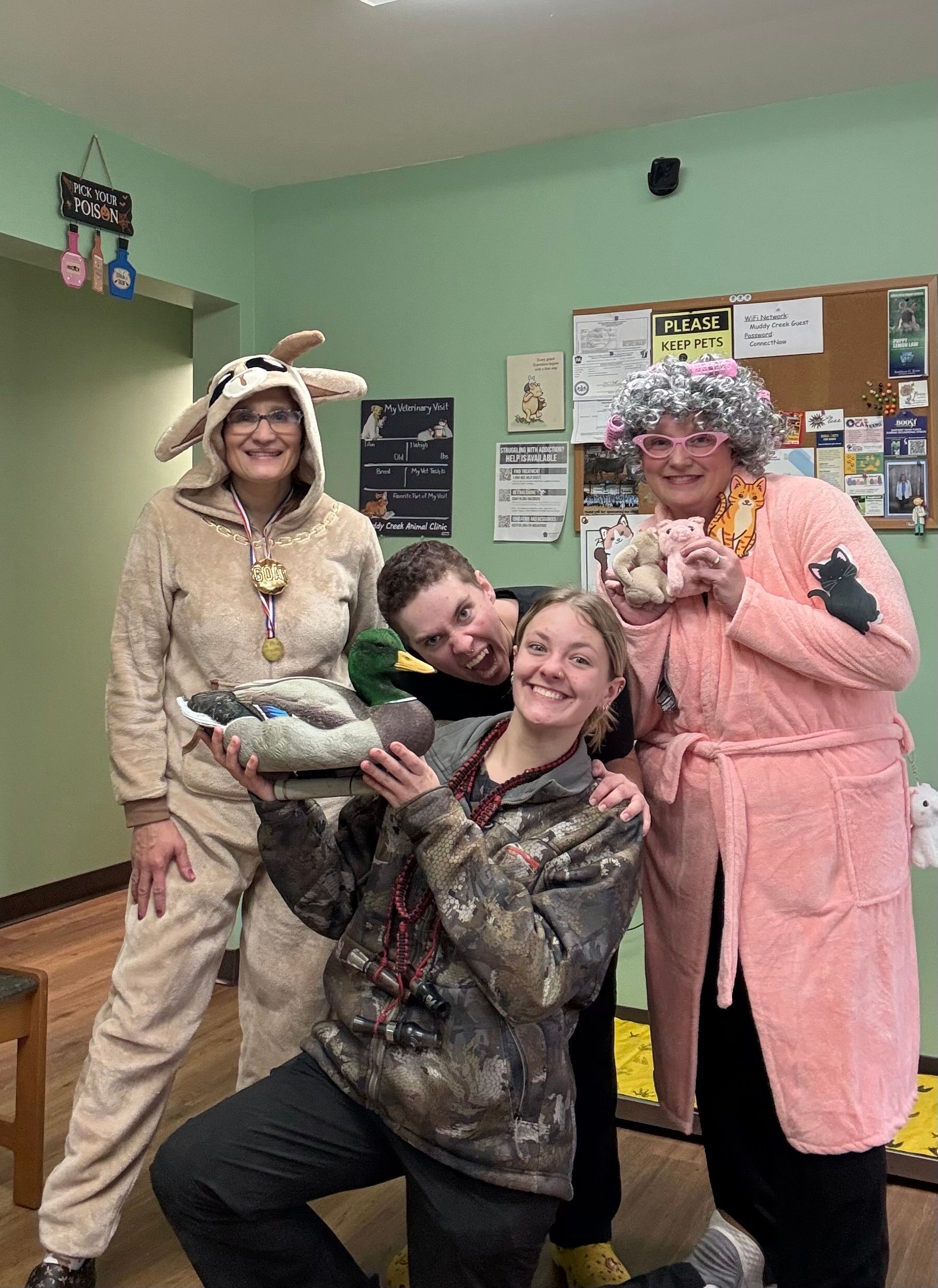 a group of women standing in front of a muddy creek dental clinic sign