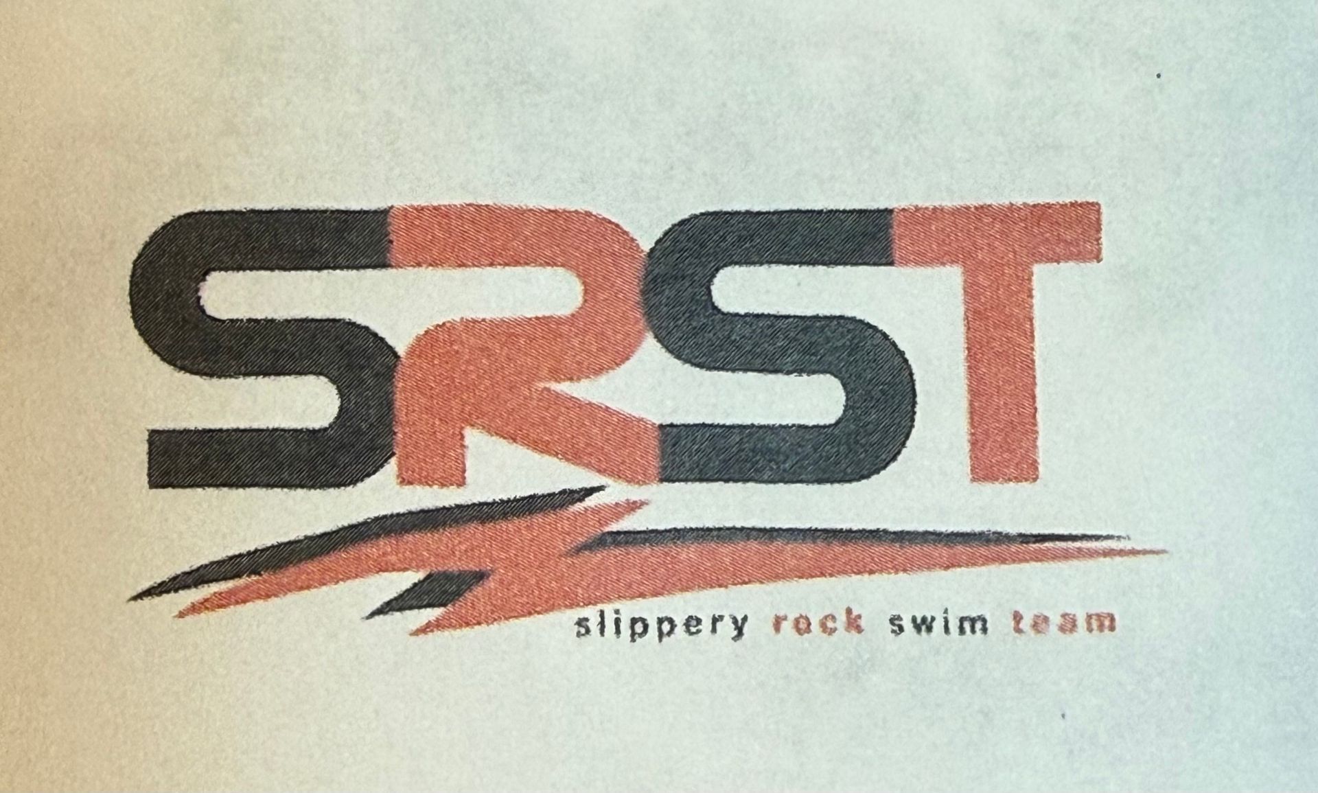 SRST logo, stylized letters with red and black color scheme. Text below reads 