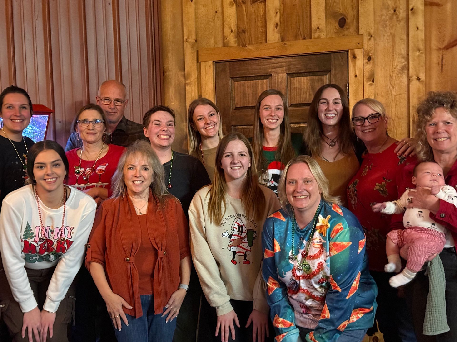 a group of women wearing blue shirts are posing for a picture .