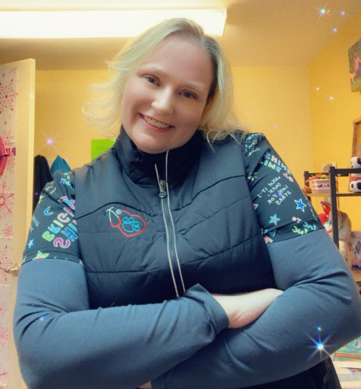 a woman in a blue shirt is standing next to a brown dog .