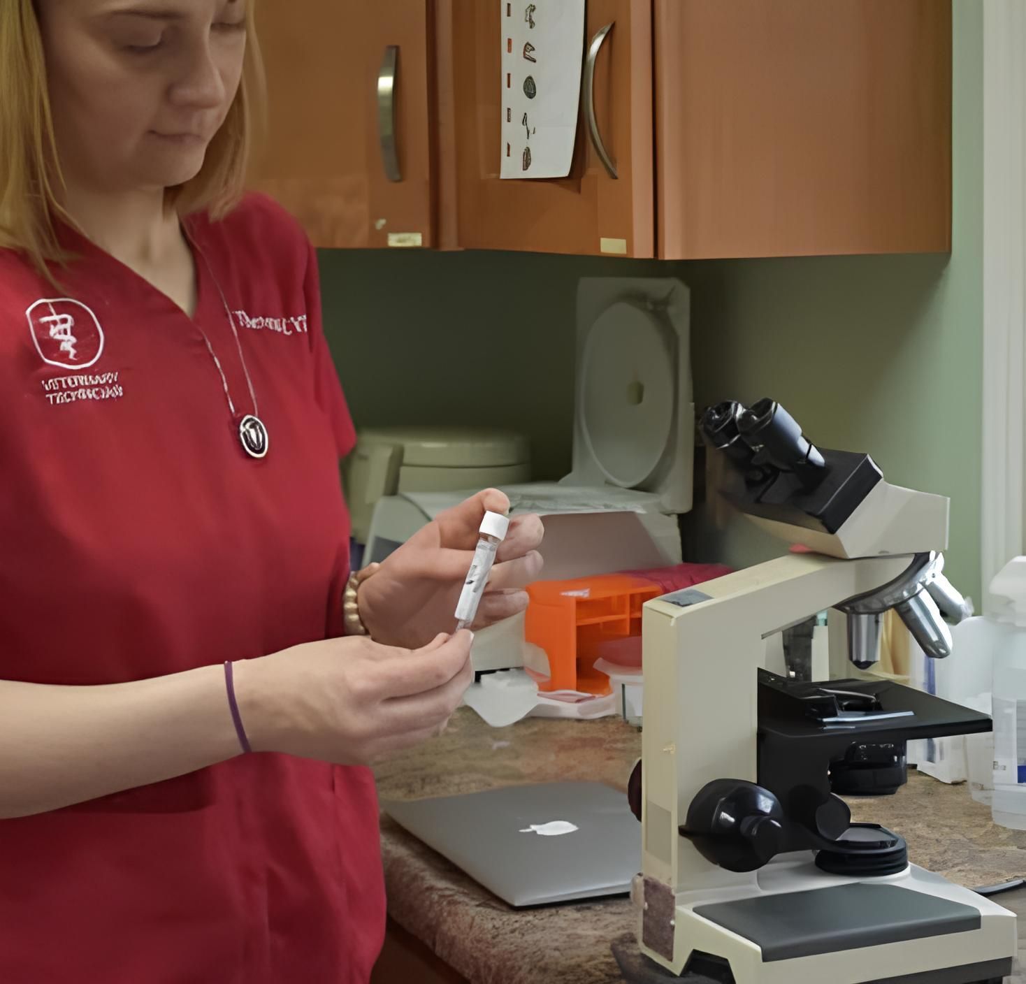 a woman in a red shirt with the word veterinarian on it