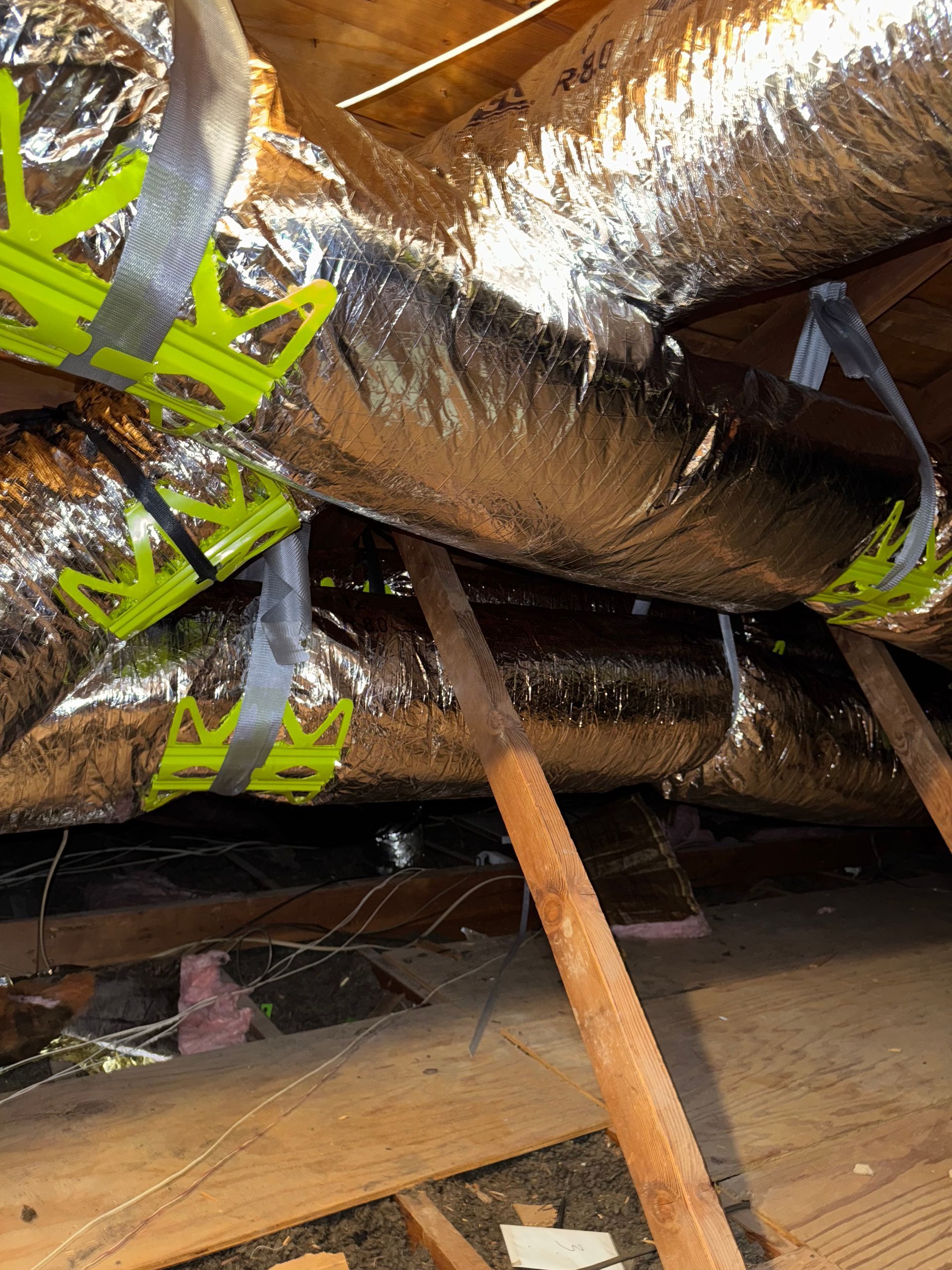 Rooftop with numerous air conditioning units, rectangular building, and small white structure.