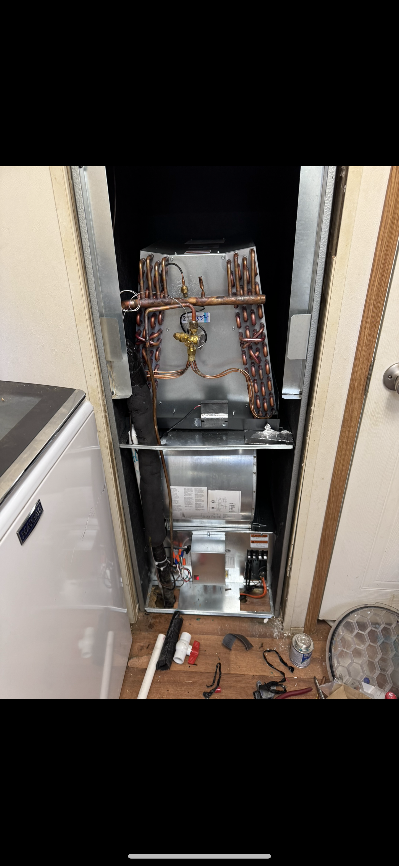 Modern living room with light pink couch, black coffee table, TV, and neutral walls.