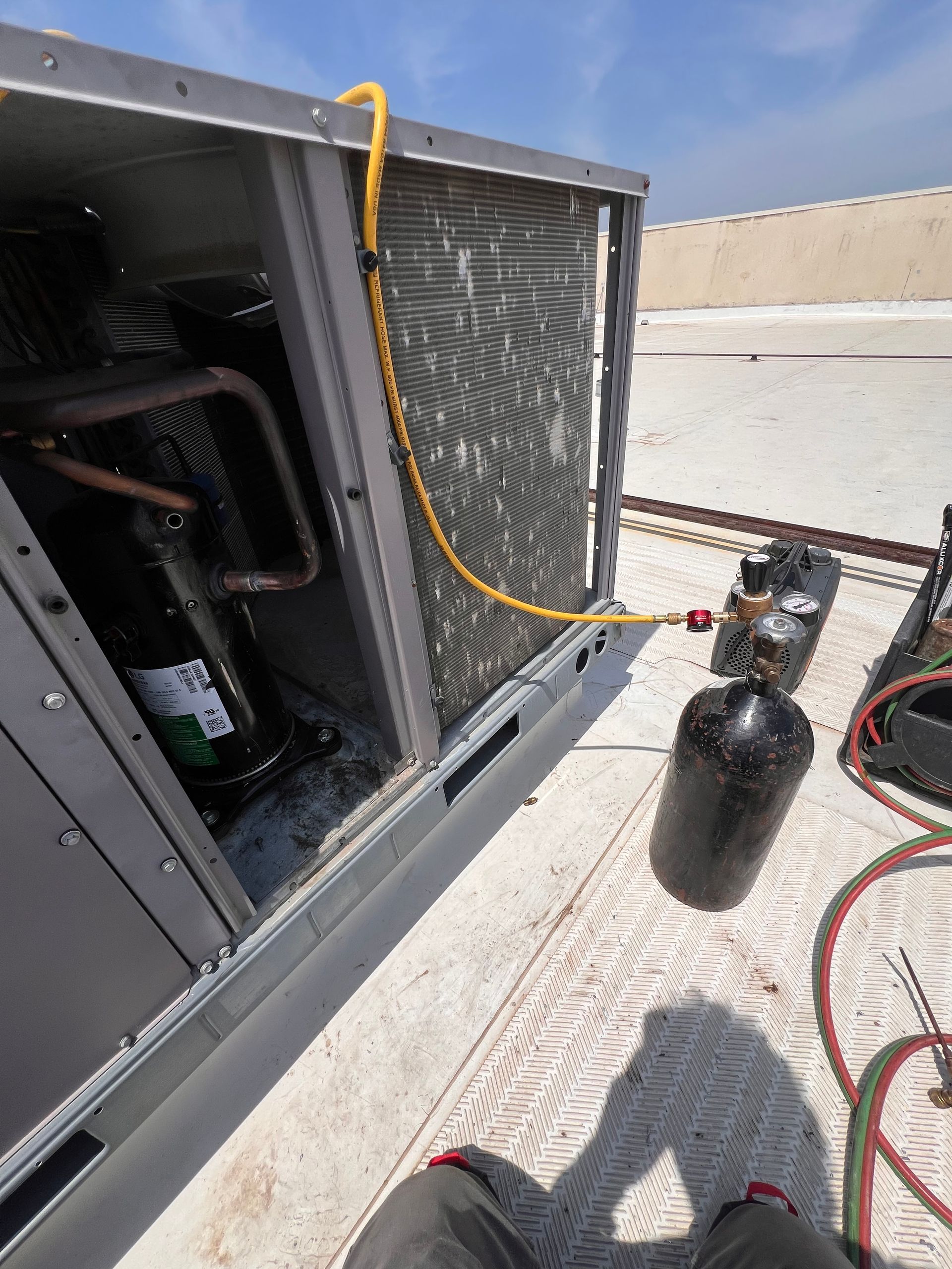 Furnace unit inside a closet with ductwork and connected wires.