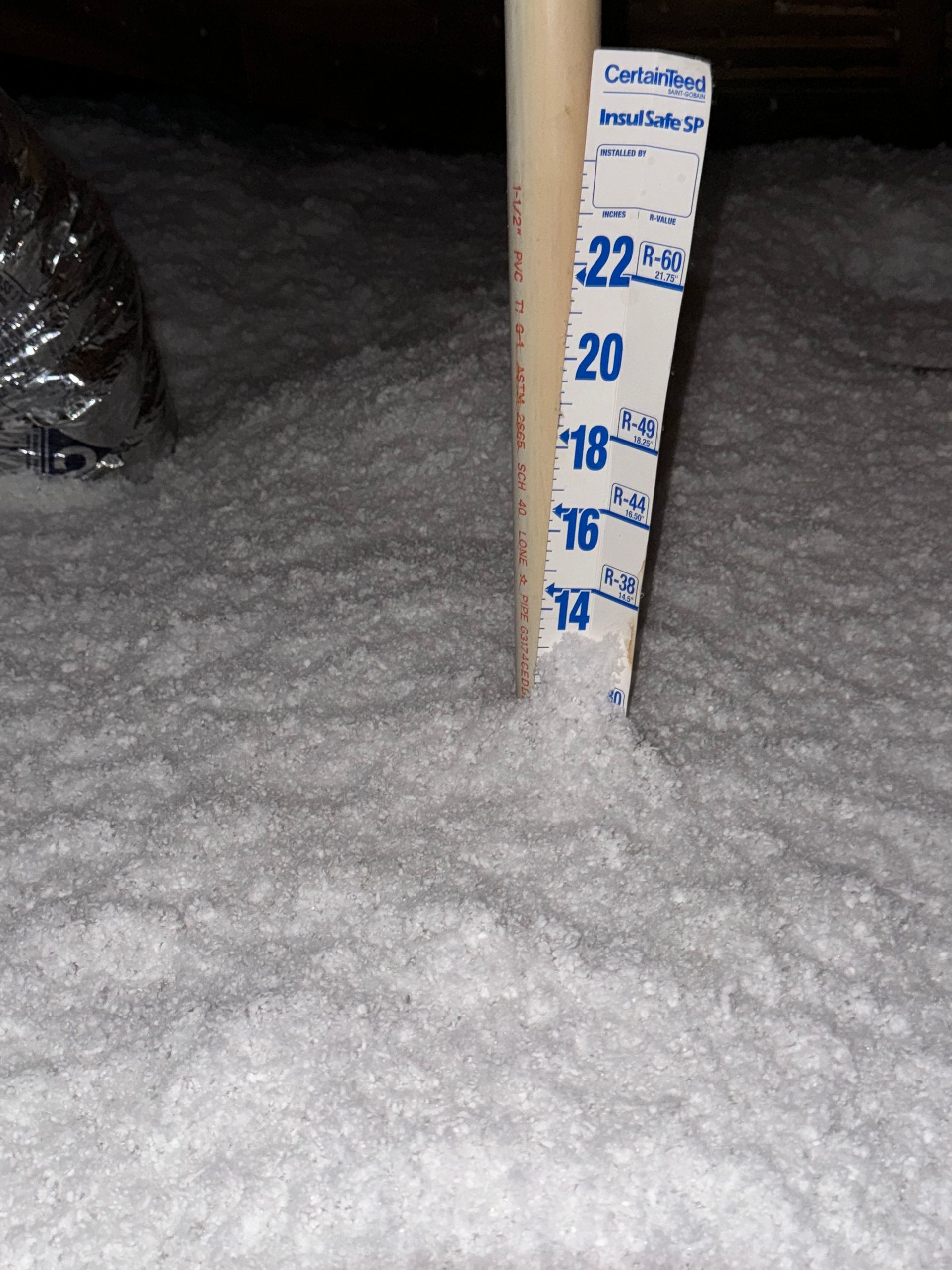 HVAC technician in blue uniform servicing a rooftop air conditioning unit, outdoor setting, brick building.