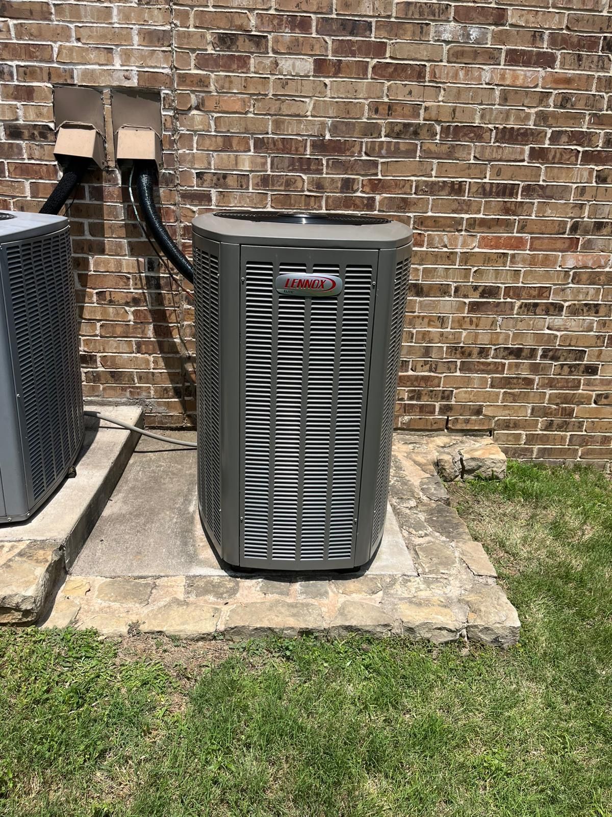 Person adjusting a boiler's controls with gloved hands. Display shows 1.9. Copper pipes and gauge are visible.