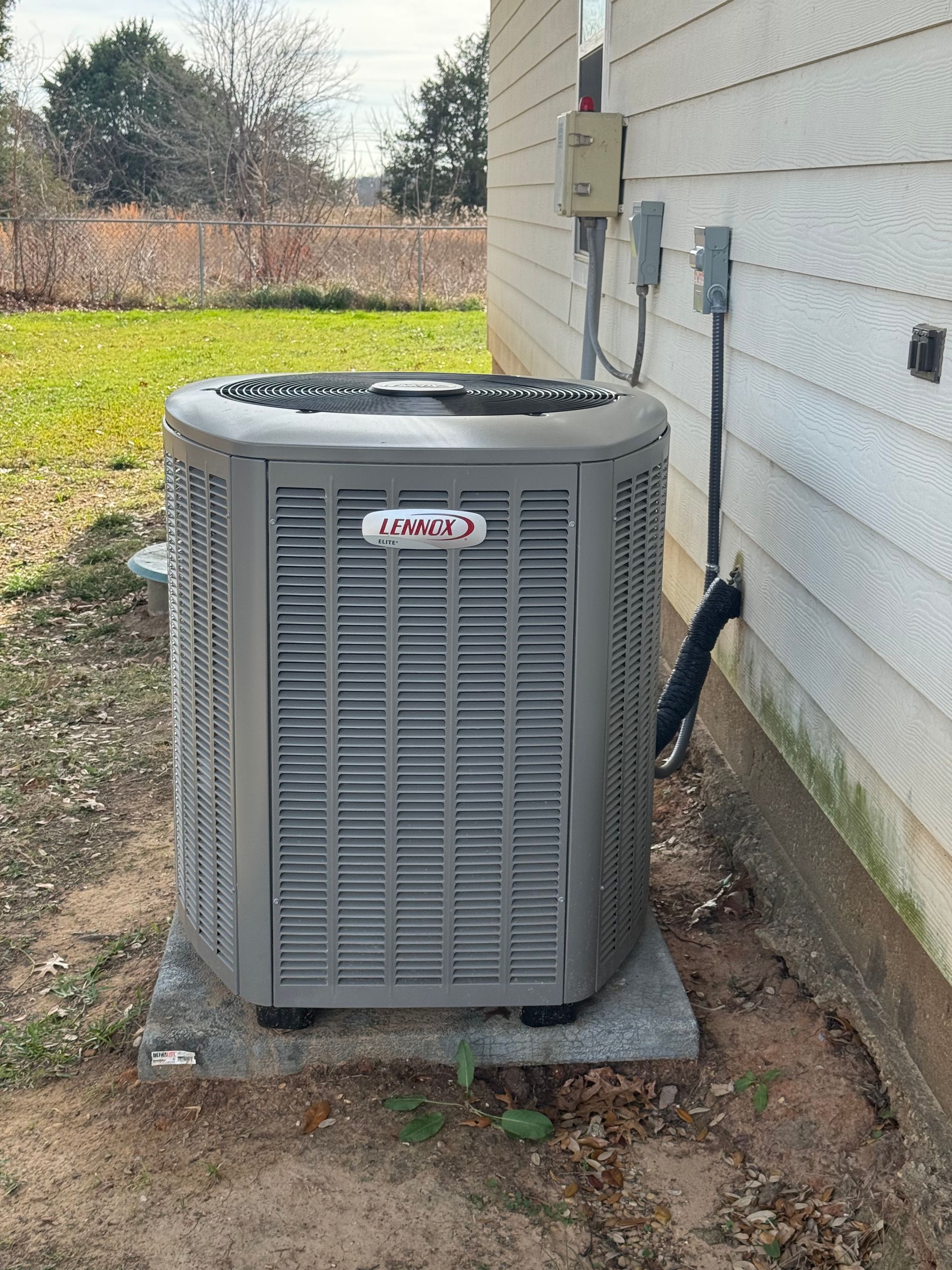 Person using a tablet to design a house with color swatches and samples on a table.
