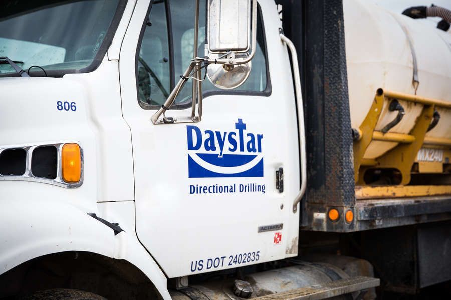White Daystar Directional Drilling truck with the company logo, parked outdoors.