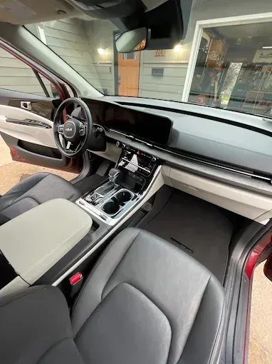 The interior of a car is shown with the door open.