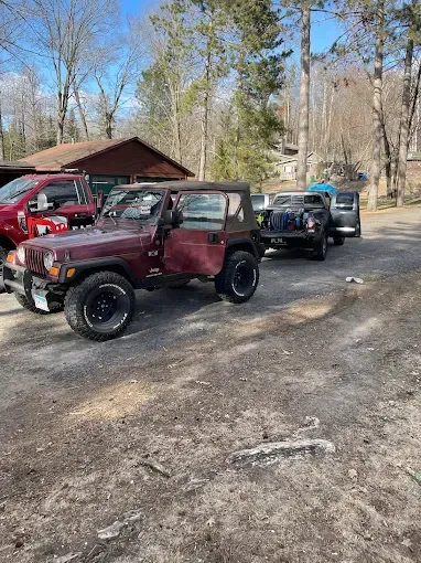 A group of jeep wranglers are parked in a parking lot.