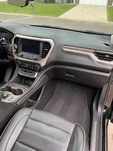 A close up of the interior of a car with the door open.