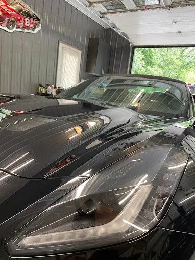 Black Corvette sports car in a garage. Paint Correction job