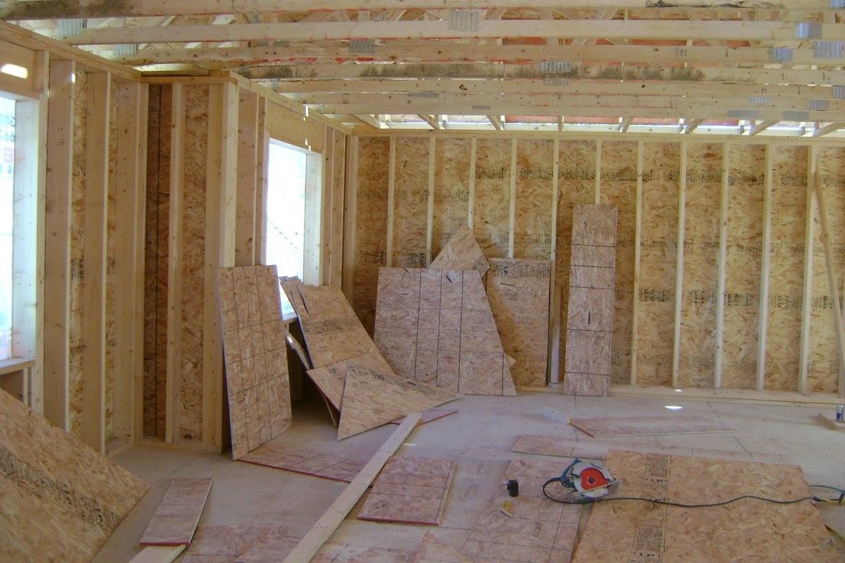 Une pièce avec beaucoup de planches de bois sur le sol et les murs.