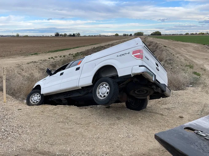 Truck in ditch needing off-road recovery