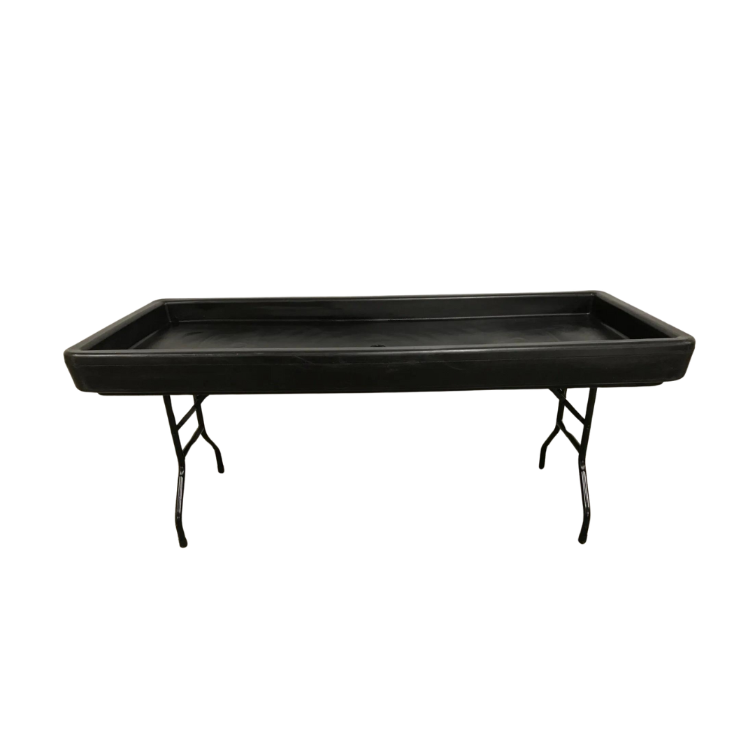 Black rectangular table with a recessed surface, supported by black folding legs, on a white background.