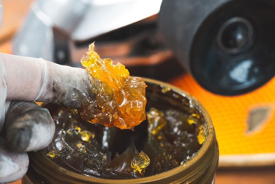 A Person is Holding a Jar of Grease in Their Hand — North Queensland Independant Fuel Services in Slade Point, QLD