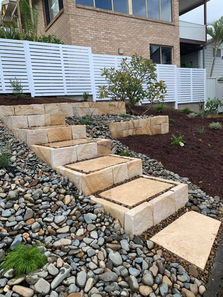 A Stone Walkway Leading Up To A House Surrounded By Rocks — Creative Landscapes Coffs Harbour In Korora, NSW