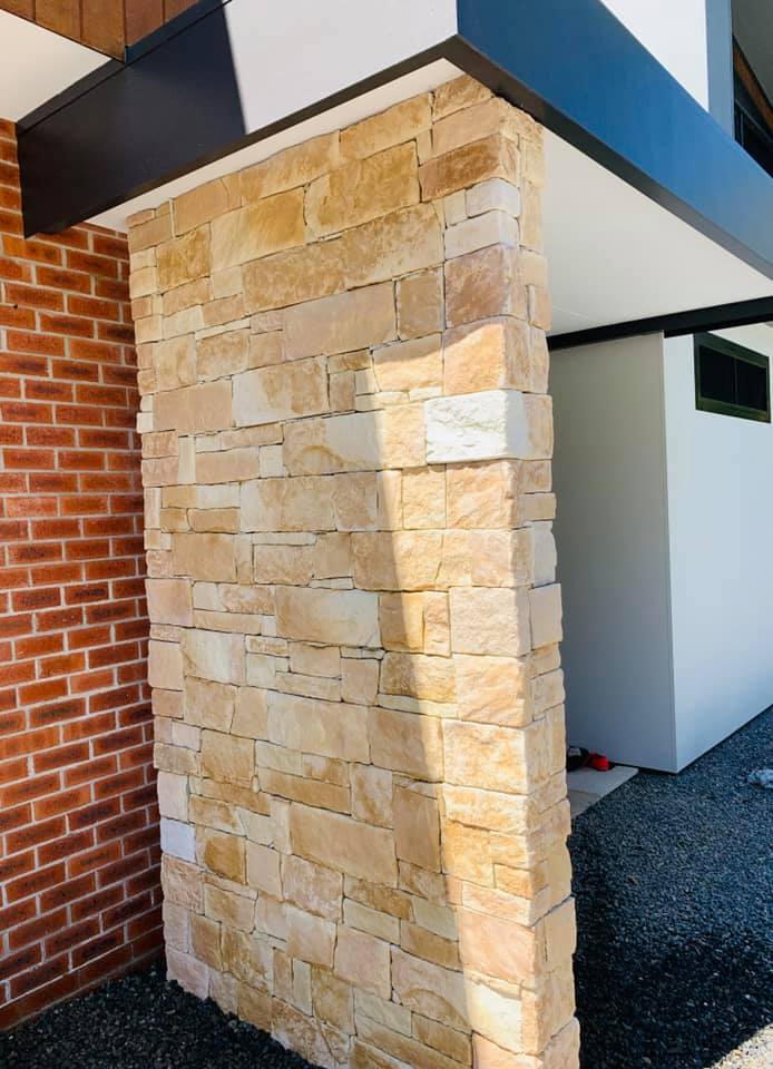 A Building With A Brick Wall And A Stone Wall — Creative Landscapes Coffs Harbour In Korora, NSW
