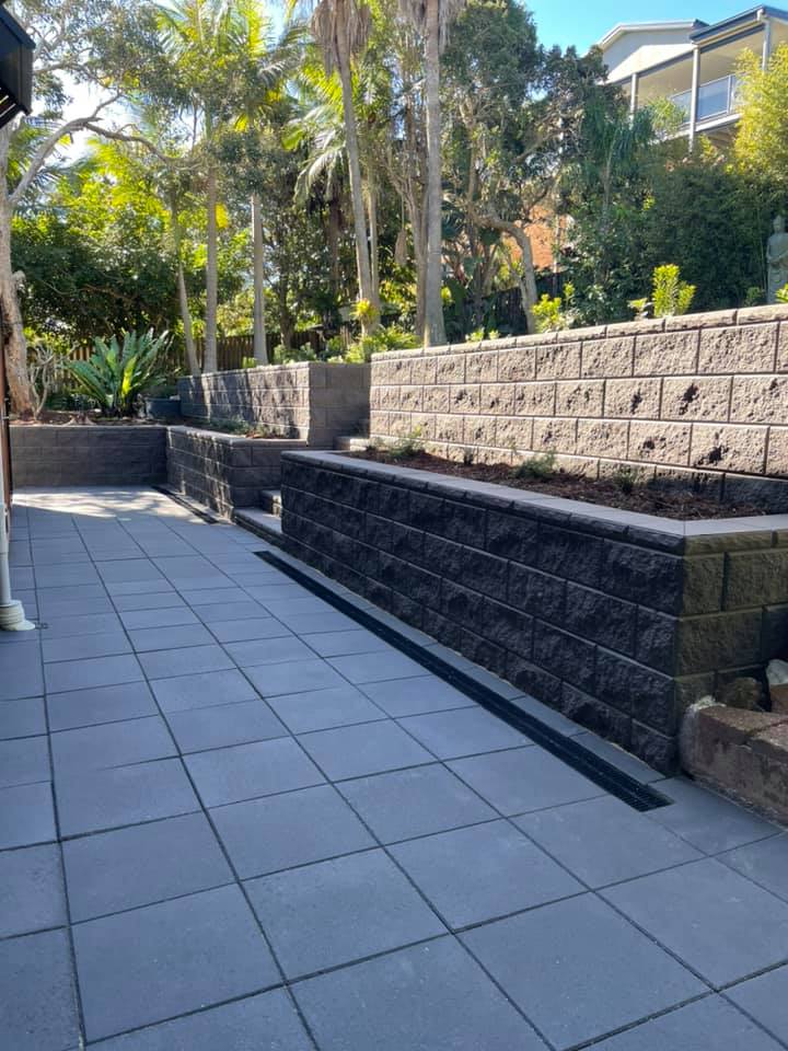 A Patio With A Brick Wall And A Drain On The Side Of It — Creative Landscapes Coffs Harbour In Korora, NSW