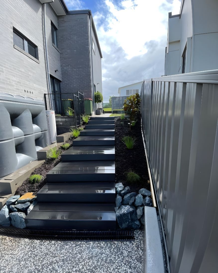 A Set Of Stairs Leading Up To A Building Next To A Fence — Creative Landscapes Coffs Harbour In Boambee, NSW