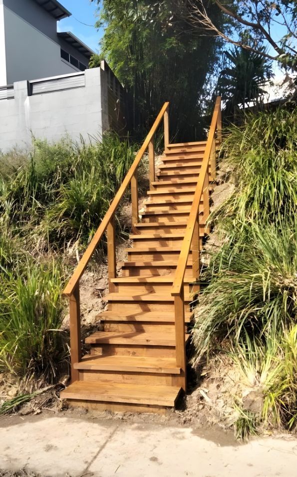 A Set Of Wooden Stairs Leading Up To A House — Creative Landscapes Coffs Harbour In Boambee, NSW