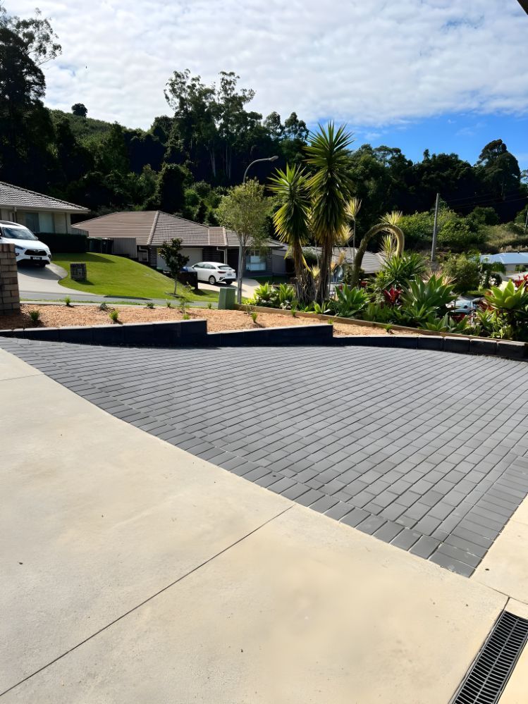 A Driveway With A Lot Of Cars Parked In It — Creative Landscapes Coffs Harbour In Korora, NSW