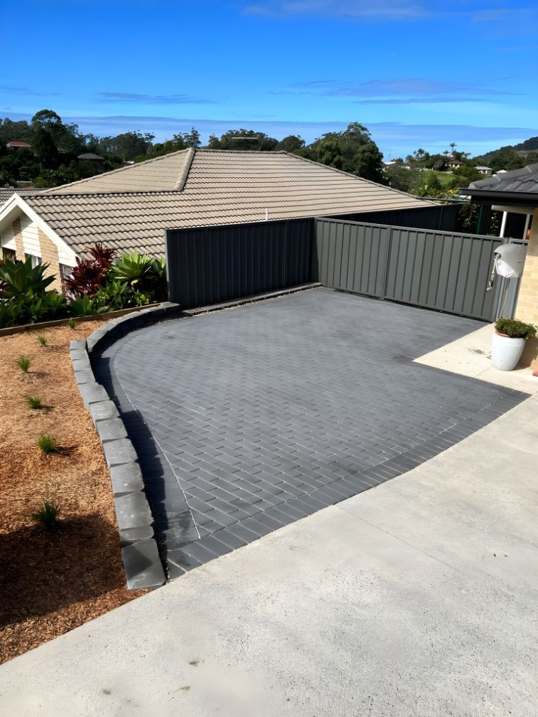 A Driveway With A Fence And A House In The Background — Creative Landscapes Coffs Harbour In Sapphire Beach, NSW