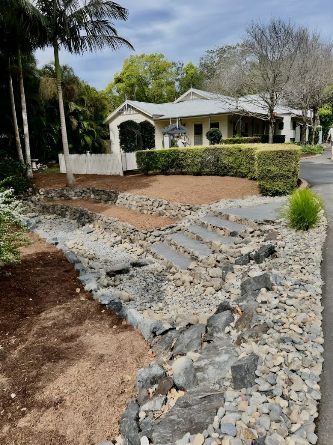 A House With A Lot Of Rocks In Front Of It — Creative Landscapes Coffs Harbour In Moonee Beach, NSW