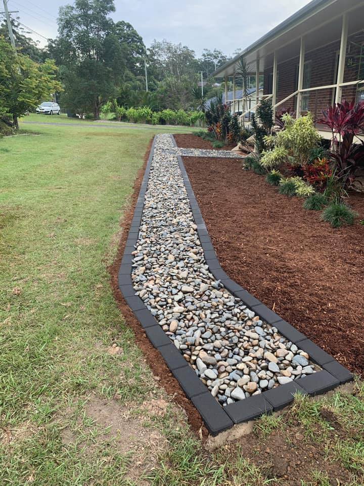 A Stone Walkway Leading To A House In A Yard — Creative Landscapes Coffs Harbour In Korora, NSW