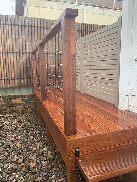 A Wooden Deck With Stairs And A Fence In The Background — Creative Landscapes Coffs Harbour In Korora, NSW