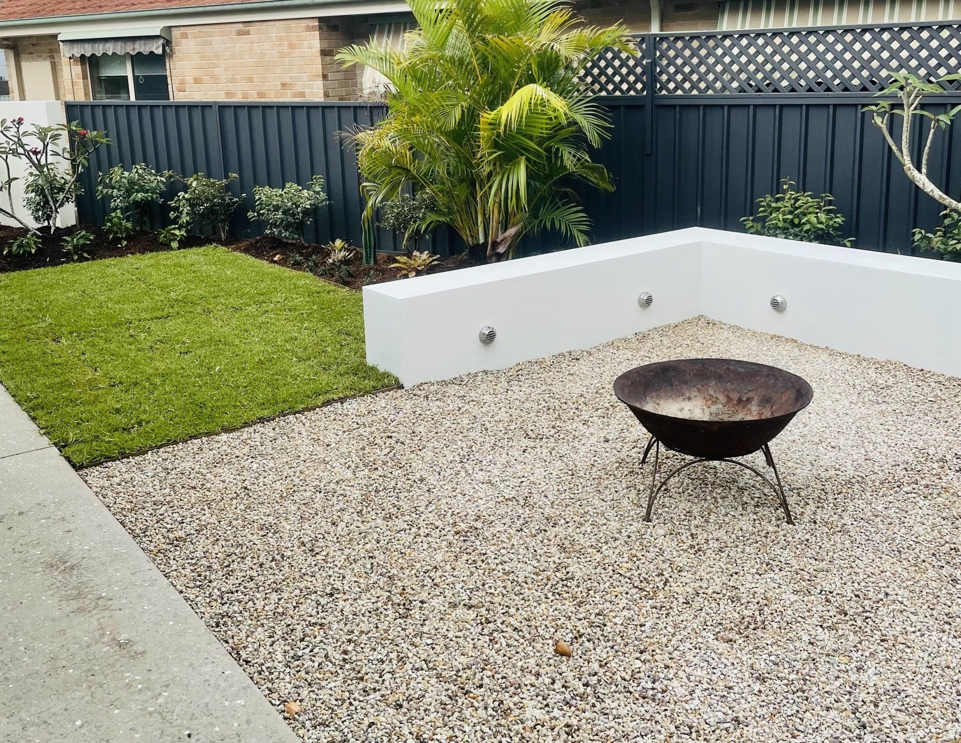 A Fire Pit Is Sitting In The Middle Of A Gravel Yard — Creative Landscapes Coffs Harbour In Korora, NSW