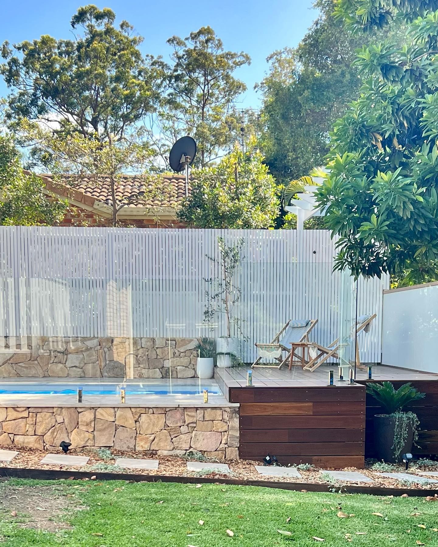 A Backyard With A Swimming Pool And A Wooden Deck — Creative Landscapes Coffs Harbour In Korora, NSW