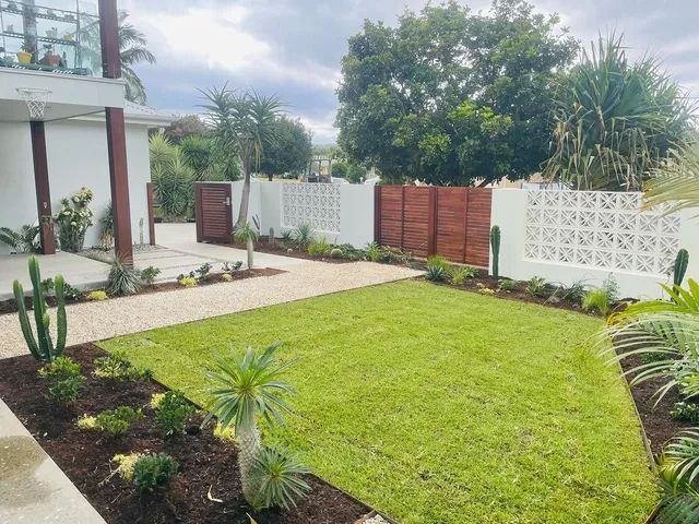 A Large Lush Green Lawn In Front Of A White House — Creative Landscapes Coffs Harbour In Korora, NSW