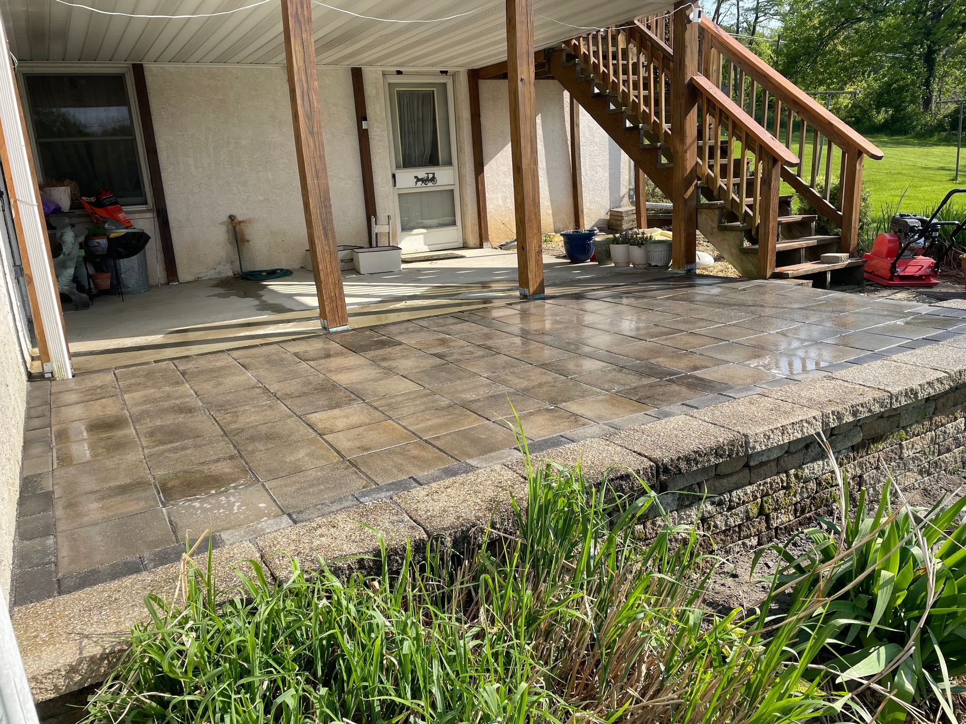 A patio with stairs leading up to a house.