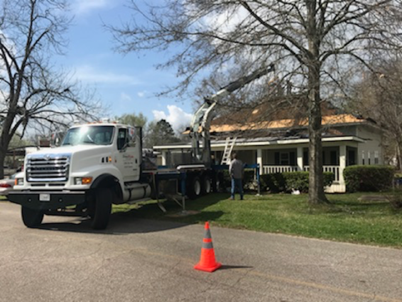 A white truck is parked in front of a house.